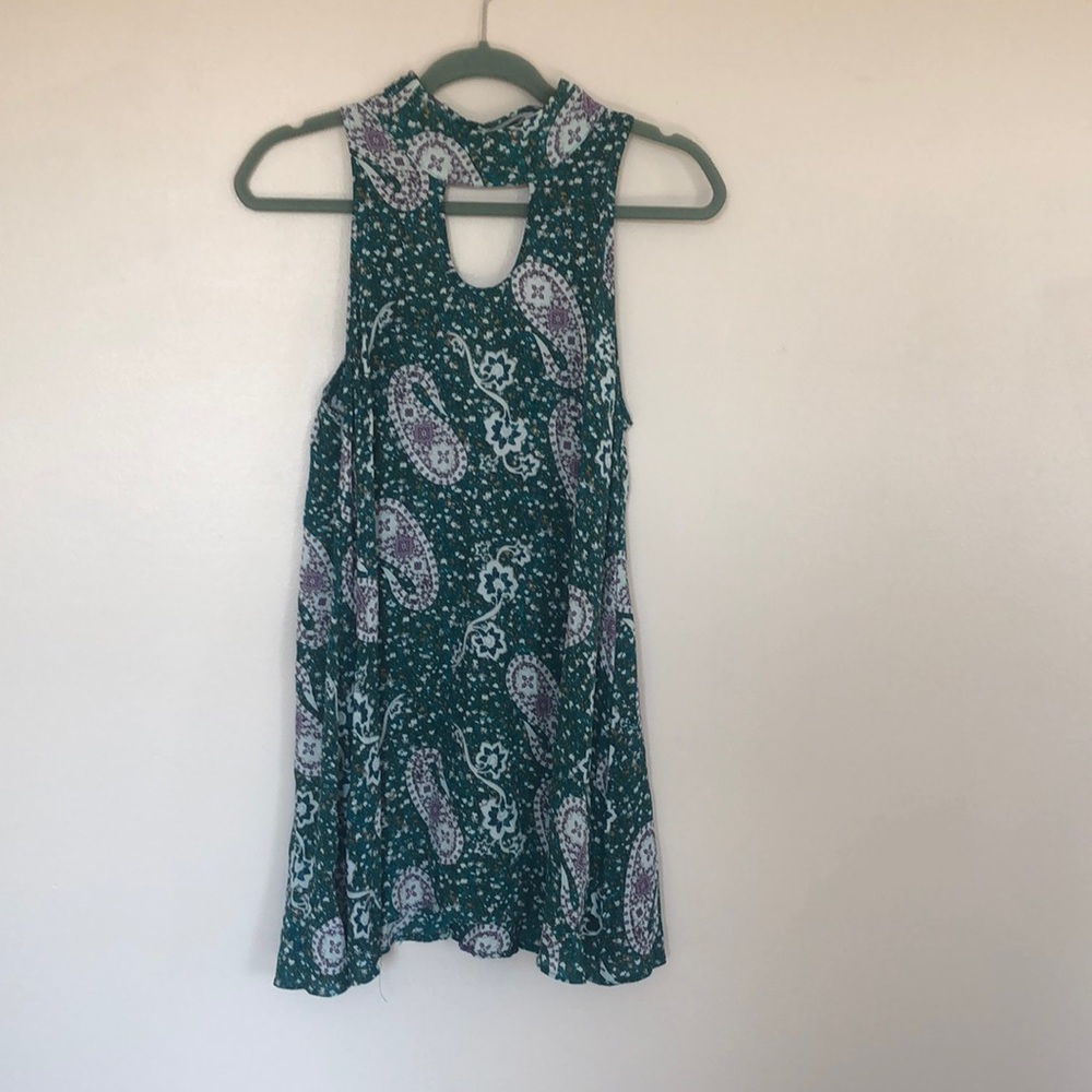 Short dress with open back and front.  Button to connect the neck. Size medium